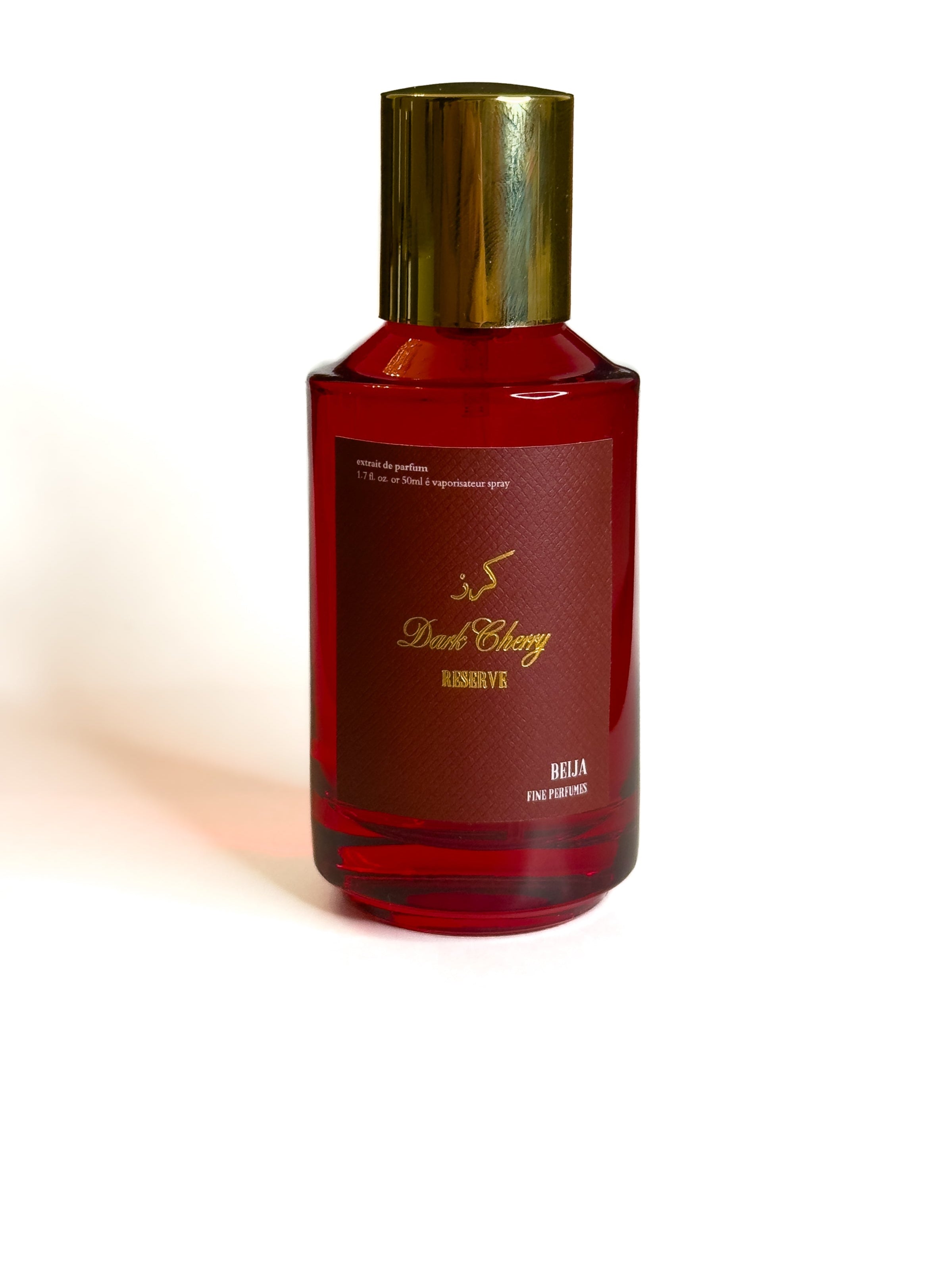 Red perfume bottle with gold cap on a white background Dark Cherry Reserve Extrait de Parfum Beija Fine Perfumes KSA